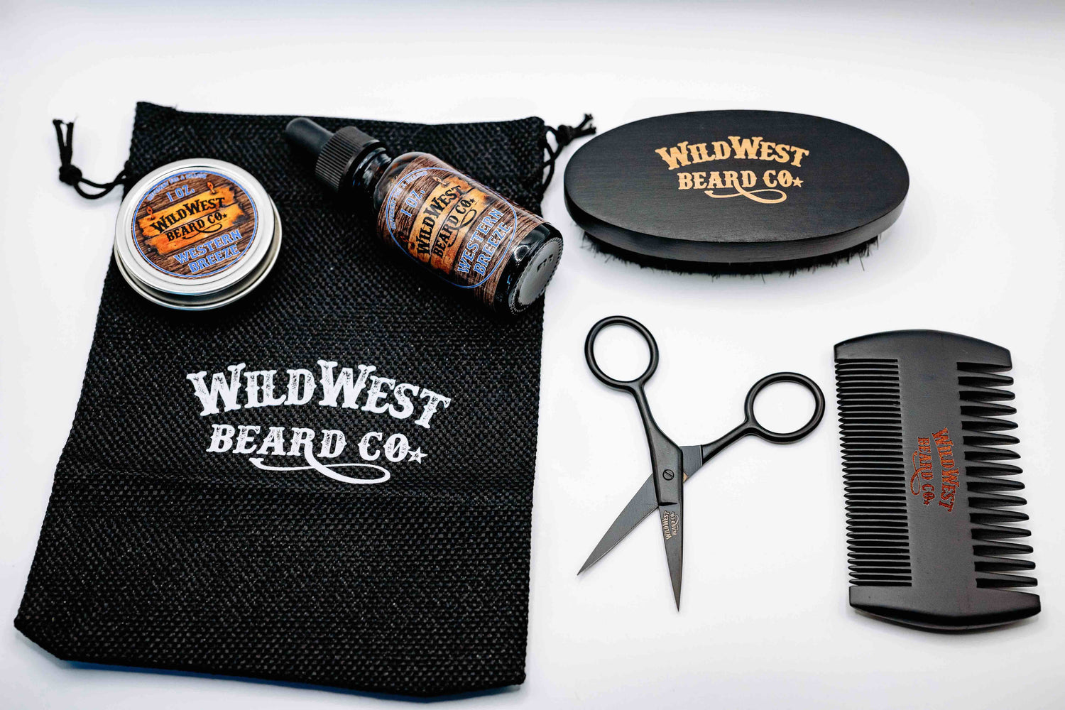 A picutre of Wild West Beard Co.'s travel kit filled with natural beard oil natural beard balm pear wood beard comb and a boars hair beech wood beard brush
