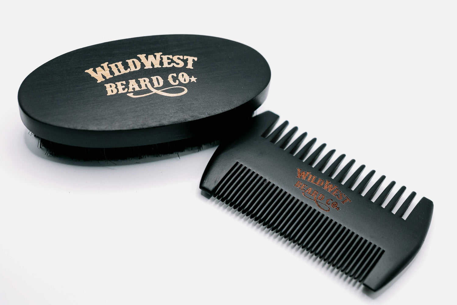 A picture of a boars hair beech wood beard brush and a pear wood comb from Wild West Beard Co.