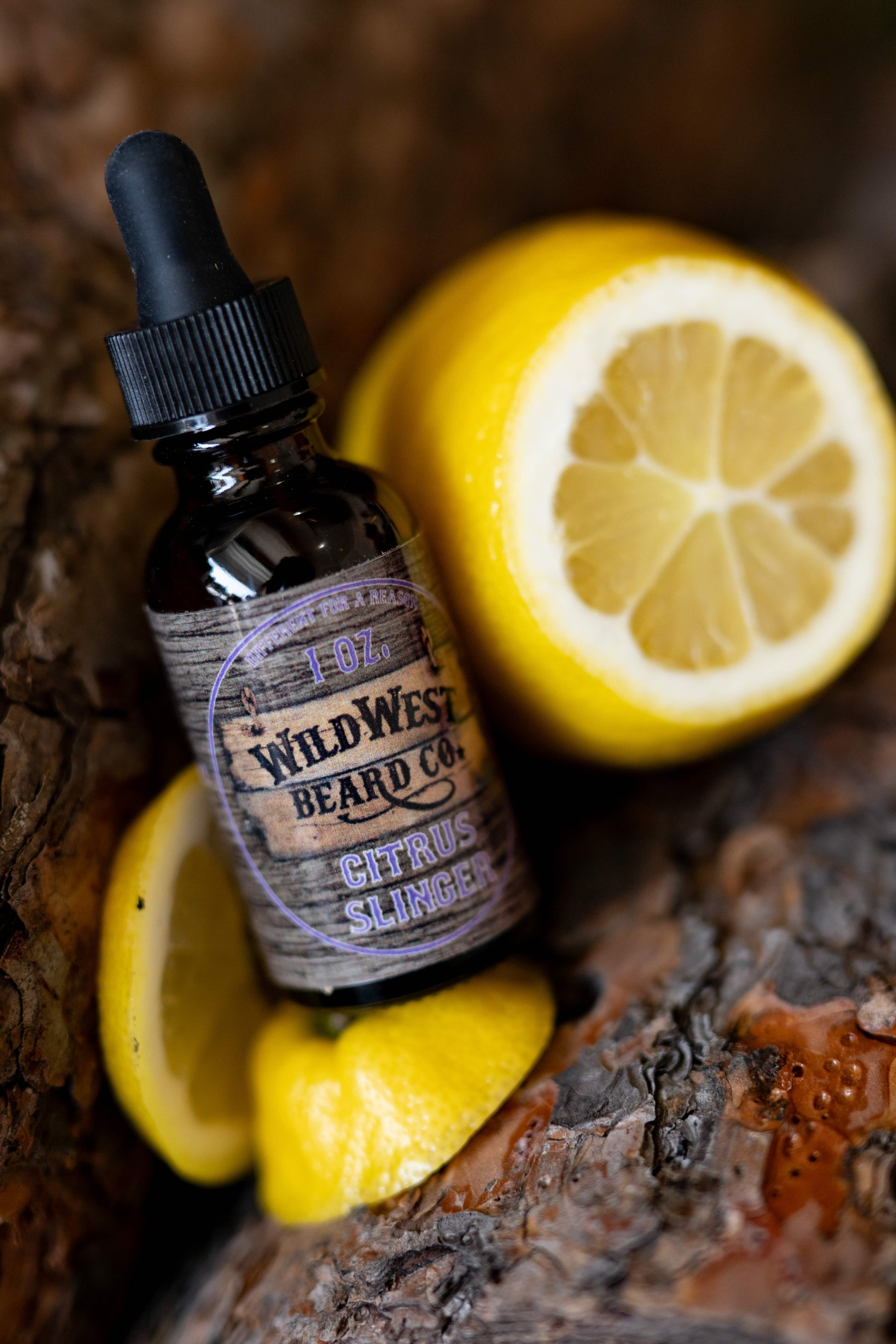 a picture of Citrus Slinger Natural Beard Oil on pine logs with lemon