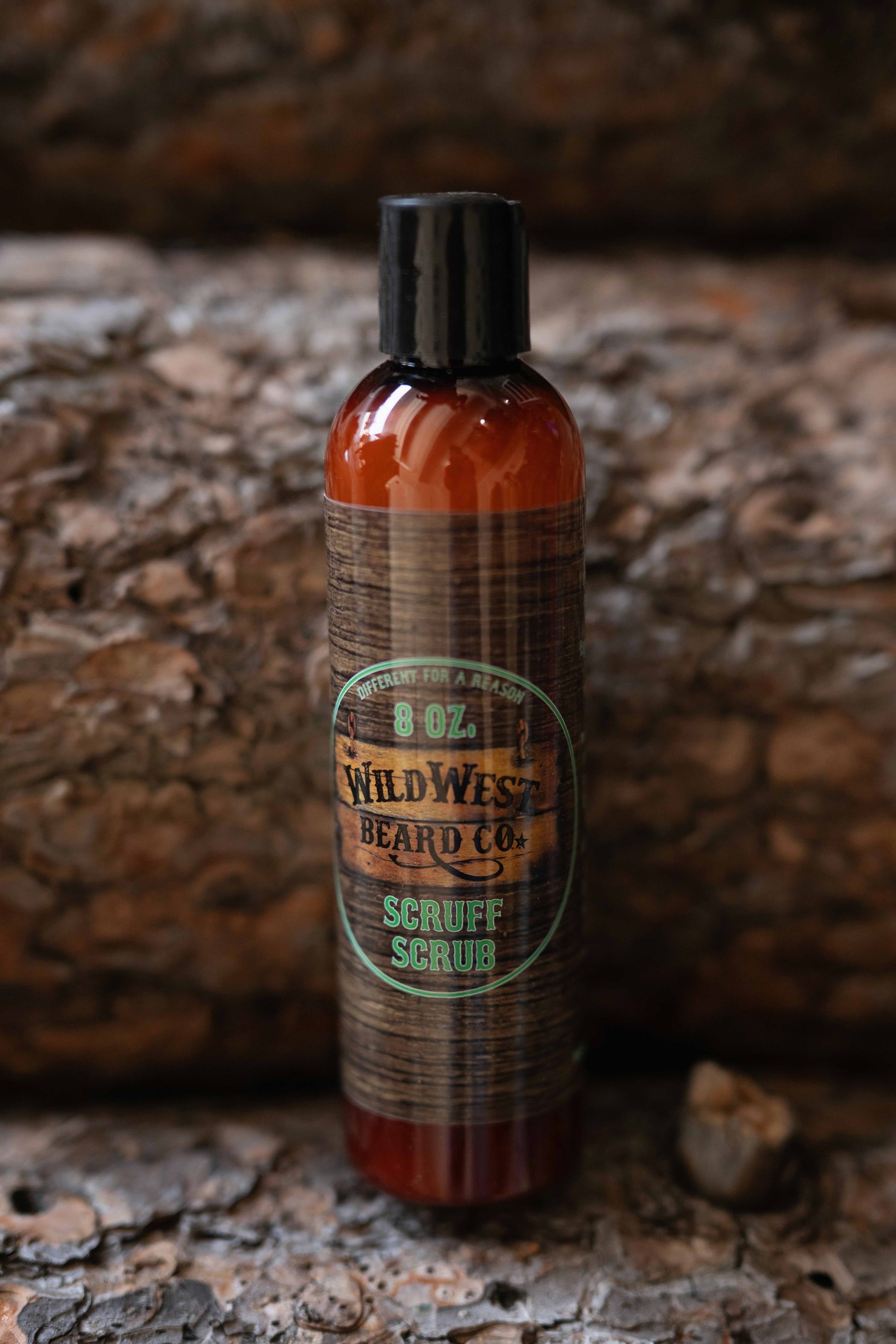 A picture of Scruff Scrub Beard Shampoo on pine logs