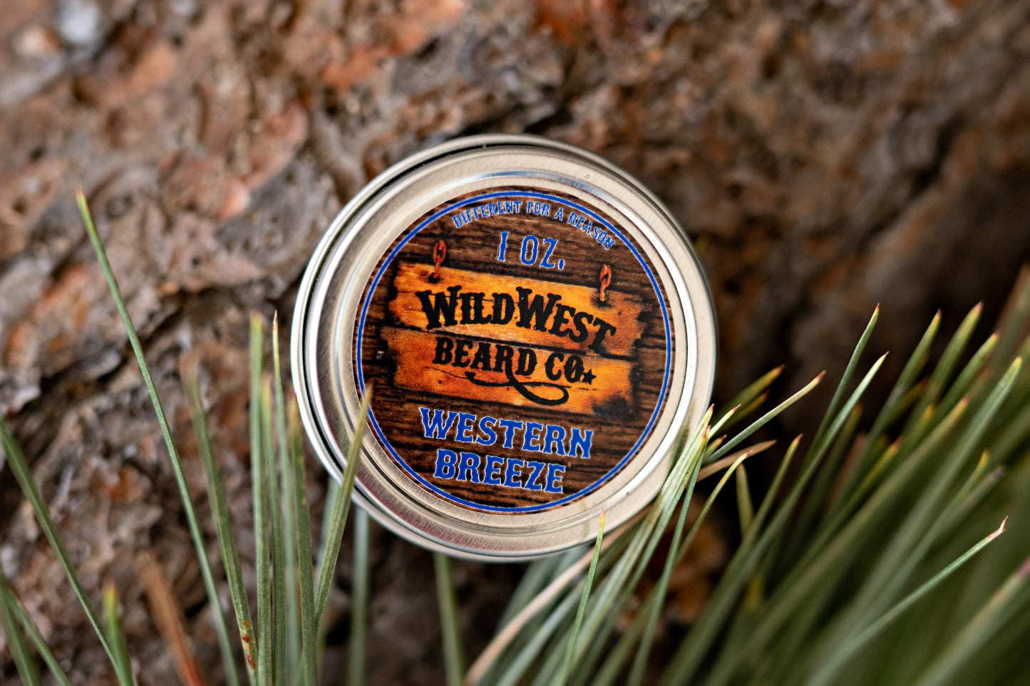 A picture of Western Breeze Natural Beard Balm with pine needles and bark
