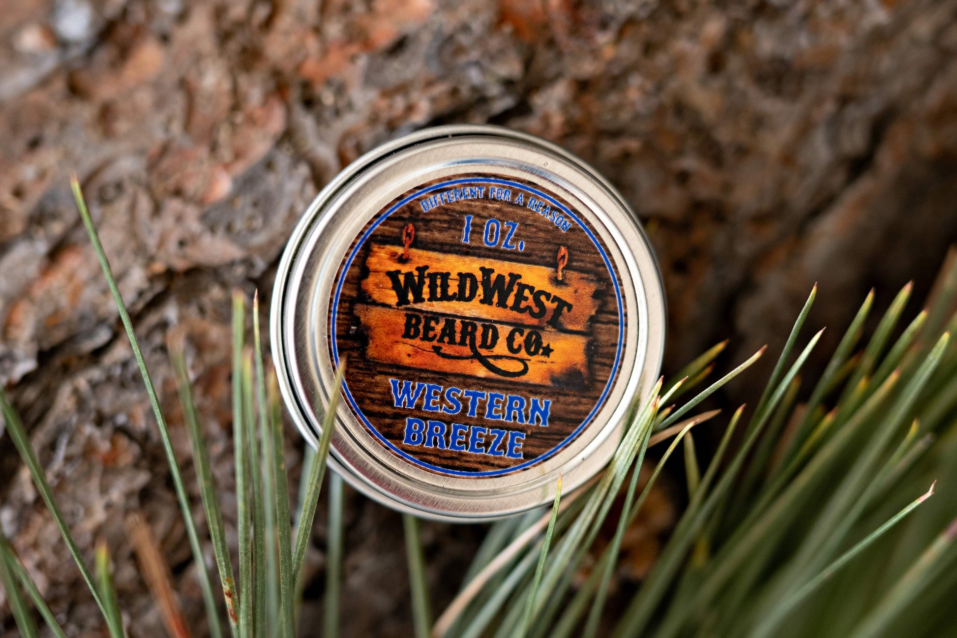 A picture of Western Breeze Natural Beard Balm with pine needles and bark